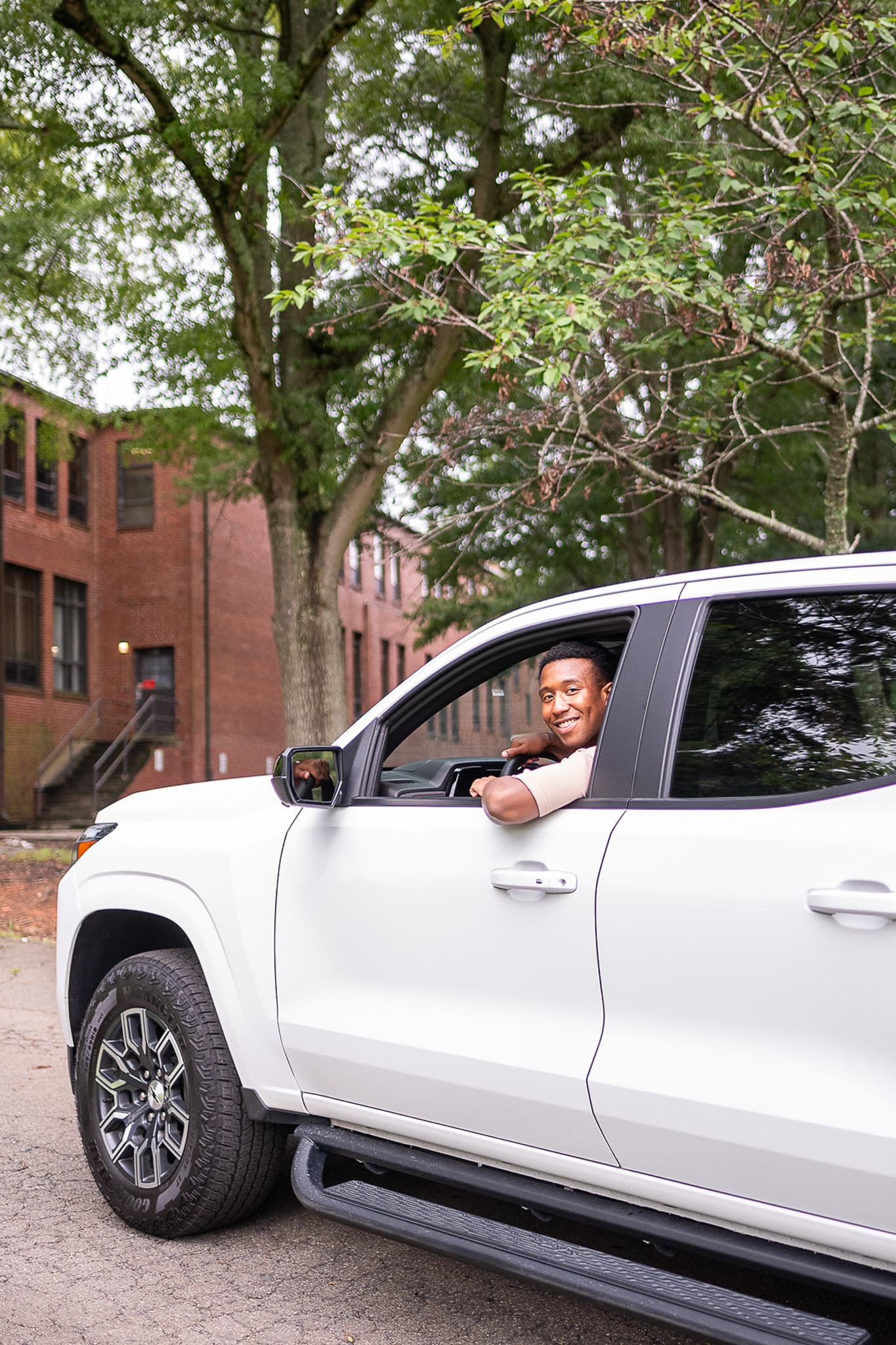 Man smiling, driving in truck
